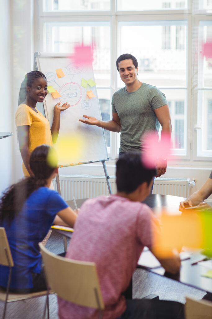 Photo de formateurs en train de discuter de leur pratique pendant une formation Avenir pro autour d'un tableau blanc